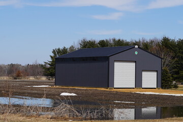 Large metal black storage unit sits on roadside holding owner belongings.