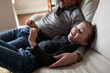 © Kelly Knox/Stocksy - father and son watching tv