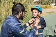 © Moy Ortega/Stocksy - Dad Putting A Helmet On A Little Boy