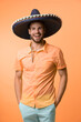 © be free - mexican man in sombrero isolated on orange. mexican man in sombrero on background.