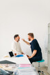 © Studio Firma/Stocksy - Physician Examining Man's Throat