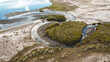 © Akela - from alp to alp/Stocksy - water channel meandering through mangroves