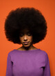 © VICTOR TORRES/Stocksy - Serious black woman with curly afro hair