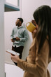 © qunica.com - A photo of black male business person talking to his colleagues at the kitchen. He is holding a cup of tea