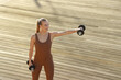 © Rene de Haan/Stocksy - woman doing exercises with dumbbells