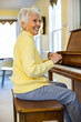 © Raymond Forbes LLC/Stocksy - Portrait of Confident Senior Citizen woman at Home playing piano