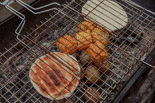Corn Cobs And Bread Are Fried On Coals With Potatoes At A Picnic