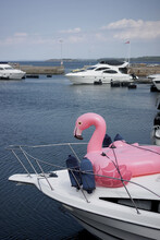 Inflatable Flamingo Toy On Deck Of A Yacht