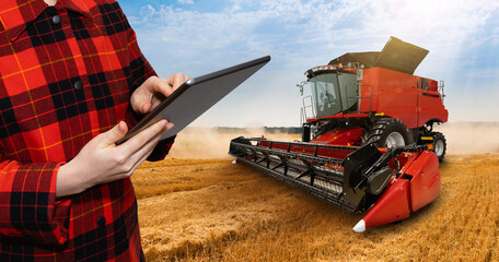 Sticker - Farmer with digital tablet on a background of harvester. Smart farming concept.	