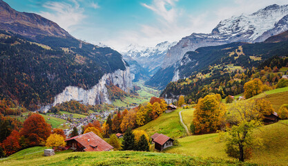 Fototapete - Wonderful Sunny landscape in Swiss alps. Wengen popular touristic village over the Lauterbrunnen valley, Switzerland. Europe. Concept of an ideal resting place. Creative image.