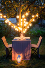 Illuminated and romatic table for two in summer garden