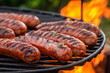 Hot sausage with spices on grill with fire in summer