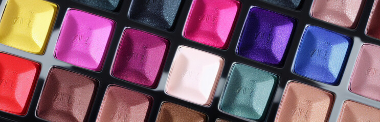 Illustration of an array of colorful eyeshadows in a makeup palette created with Generative AI technology