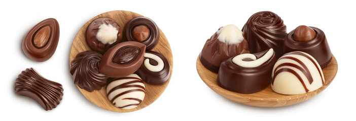 Wall Mural - Chocolate candy in wooden bowl isolated on white background with  full depth of field. Top view. Flat lay