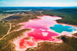 The vibrant pink lakes of Western Australia offer a striking summer travel background, with water that appears to be painted with bright, bubblegum hues