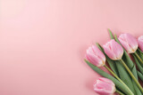 Fototapeta Tulipany - Bouquet of pastel pink colored tulips flowers on pastel pink background. Valentine's Day, Easter, Birthday, Happy Women's Day, Mother's Day. Flat lay, top view, copy space