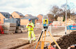 © Iryna - Surveyor builder site engineer with theodolite total station at construction site outdoors during surveying work