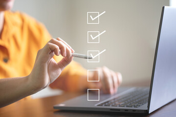 business performance checklist concept, businessman using laptop doing online checklist survey, fill
