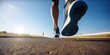 © YuDwi Studio - Close - up at the runner feet is running street in blue sky in the city, street and road. Trail running sport action and human challenge concept by ai generative