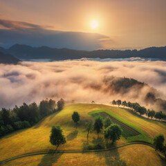 Wall Mural - aerial view of alpine meadows and mountains in low clouds at amazing sunrise in summer. top drone vi
