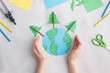 © Angelina Zinovieva - earth cut from paper around trees earth day concept kid's paper craft