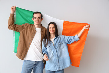 Sticker - Young couple with flag of Ireland on light background