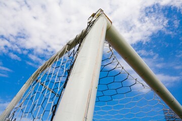 STADIUM - Football field with goal and tablo on blue sky