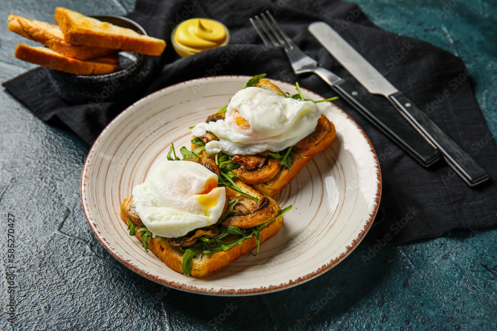 Plate with tasty eggs Benedict on black background