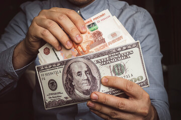 Hands take out russian rubles from wallet. Closeup on man's hands as he is getting a banknote out of his wallet. a lot of money. a rich man. income from trading on the stock exchange concept