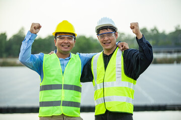 two engineer worker working together at solar panel.