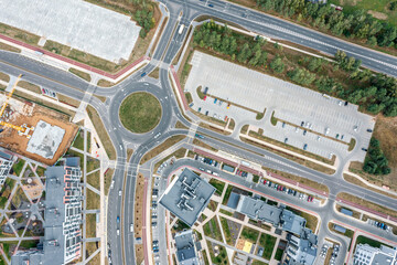 Wall Mural - roundabout circular intersection road and parking lots in city residential area. aerial top view.