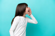 © luismolinero - Little caucasian girl isolated on blue background shouting with mouth wide open to the side