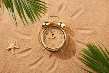 Wall Mural - Alarm clock on a sandy beach. Noon, 12 p.m. A dangerous time for tanning and being in the sun.Sand texture, natural background. Top view.