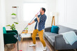 © AntonioDiaz - Happy caucasian man having fun sweeping the floor