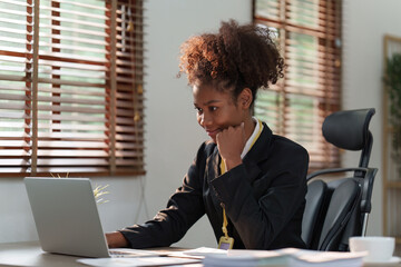 Wall Mural - Accountant black woman working on laptop and do document, tax, exchange, accounting and Financial advisor concept