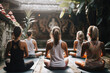 Girls making yoga in the lotus position. Tropical background