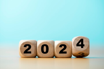 Wall Mural - flipping of 2023 to 2024 on wooden block cube for preparation new year change and start new business
