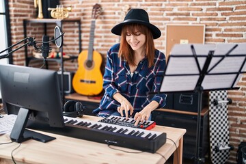 Canvas Print - Young woman musician playing piano keyboard at music studio