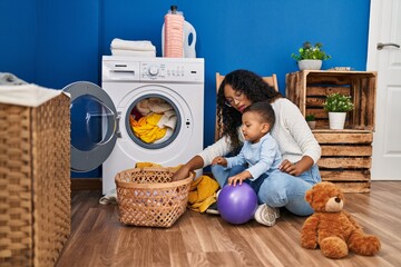 Canvas Print - Mother and son smiling confident washing clothes at laundry room