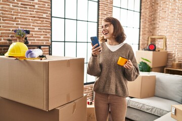 Poster - Young caucasian woman having video call drinking coffee at new home