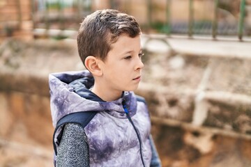 Poster - Blond child with relaxed expression standing at street