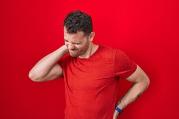 Sticker - Young hispanic man standing over red background suffering of neck ache injury, touching neck with hand, muscular pain