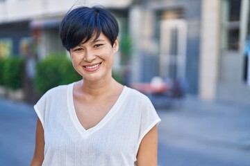 Sticker - Middle age chinese woman smiling confident standing at street