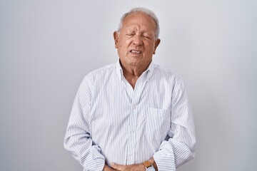 Sticker - Senior man with grey hair standing over isolated background with hand on stomach because indigestion, painful illness feeling unwell. ache concept.