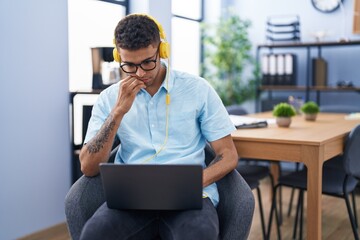 Canvas Print - African american man business worker using laptop and headphones at office