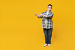 Full body young happy man with down syndrome wear glasses casual clothes point index fingers aside on workspace area isolated on pastel plain yellow color background Genetic disease world day concept