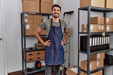 Wall Mural - Young hispanic man business worker smiling confident standing at storehouse