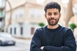 © Krakenimages.com - Young arab man smiling confident standing with arms crossed gesture at street