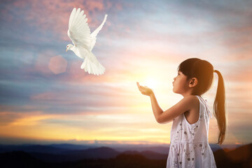 Canvas Afdrukken
 - White dove flying out of Girl child hand on beautiful background.freedom concept ,International Working Women's Day