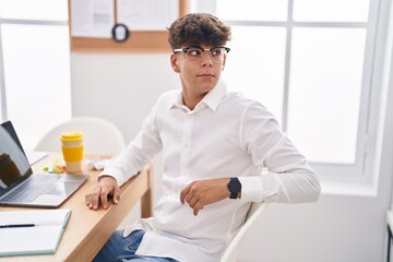 Poster - Young hispanic teenager business worker using laptop working at office